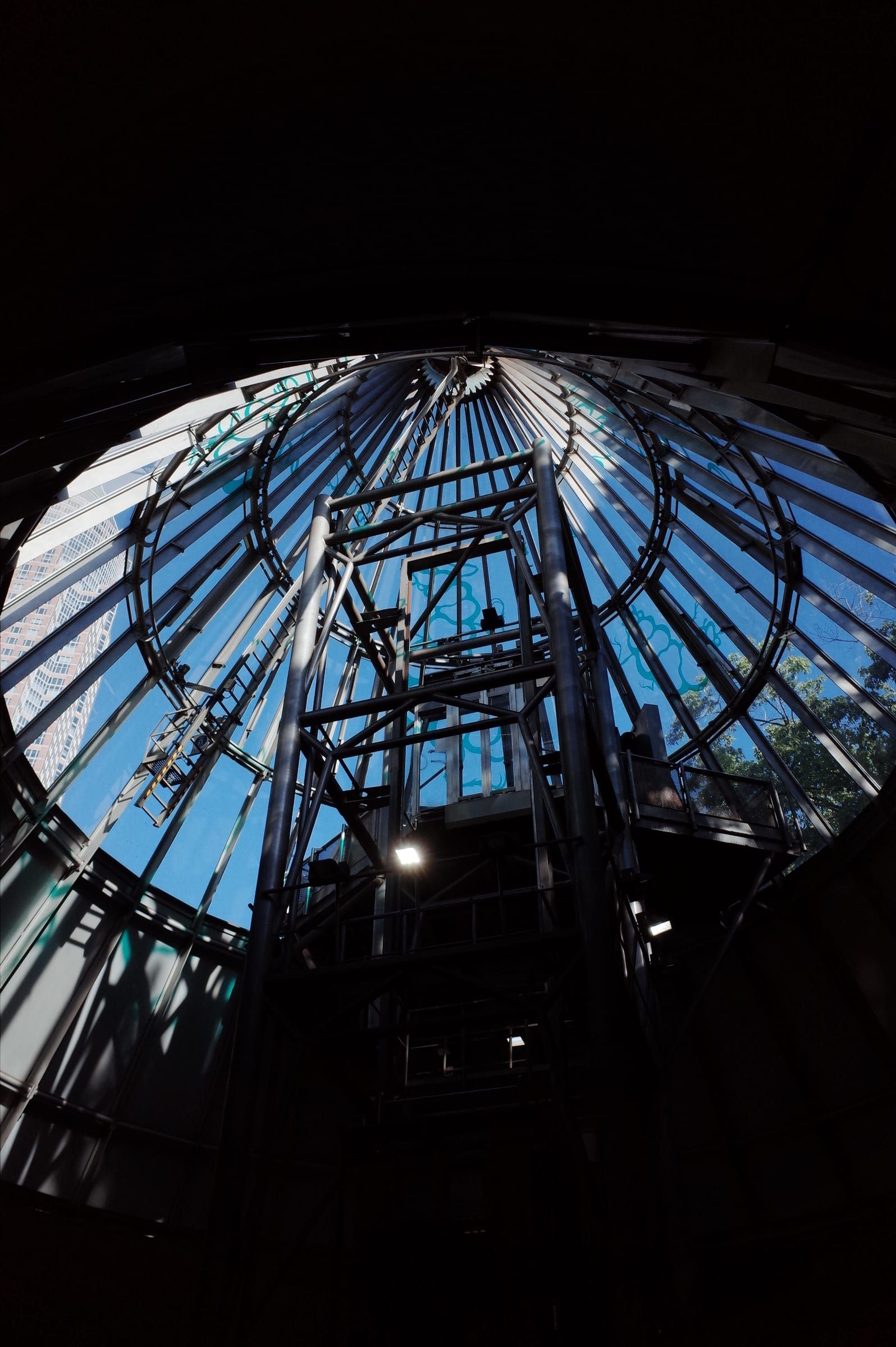 Glass and steel elevator shaft at a subway station